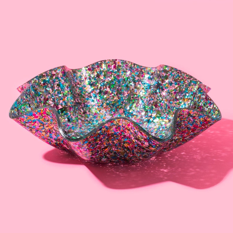 A bowl with a wavy rim and glitter inside