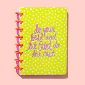 May include: A yellow notebook with a white heart pattern and the text "do your best and let God do the rest" in pink and blue lettering. The notebook has a pink and orange spiral binding.
