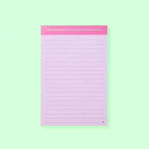 May include: A lined notepad with a pink cover and a light purple interior. The top of the notepad has the text "YOU ARE RESPONSIBLE FOR THE ENERGY YOU BRING TO THIS ROOM". A small heart is at the bottom.
