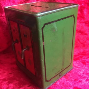 A lovely old vintage money box in the form of a old safe strong box tin with cast base. image 2