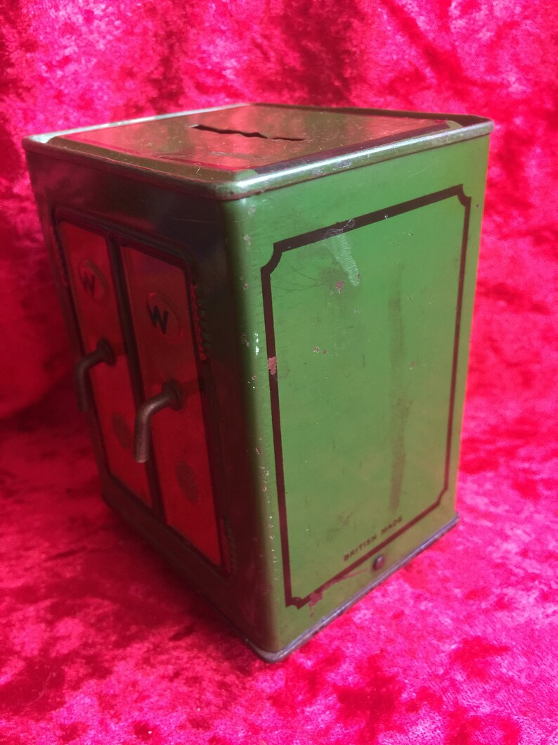 A lovely old vintage money box in the form of a old safe strong box tin with cast base. image 2