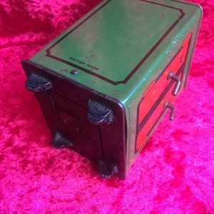 A lovely old vintage money box in the form of a old safe strong box tin with cast base. image 9