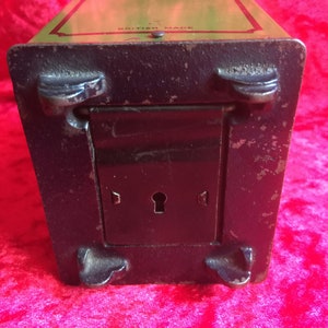 A lovely old vintage money box in the form of a old safe strong box tin with cast base. image 6