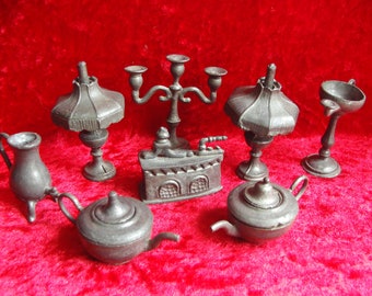A collection of old pewter miniature dolls house items table lamps teapots urns candlestick etc.