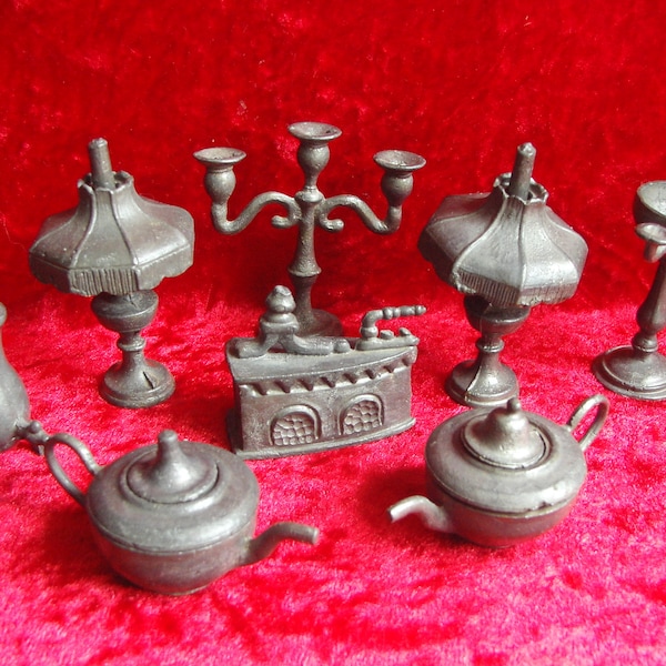 A collection of old pewter miniature dolls house items table lamps teapots urns candlestick etc.