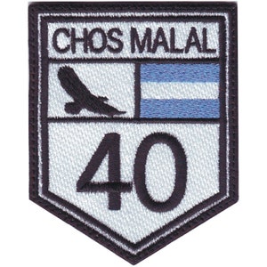 May include: A white and black embroidered patch with the text "CHOS MALAL" and the number "40". A stylized eagle and a blue and white flag are also featured on the patch.