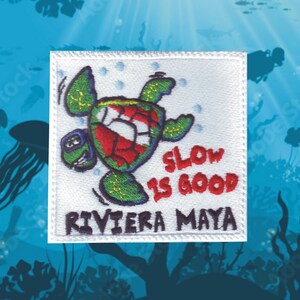 May include: White embroidered patch with a cartoon sea turtle swimming with the text "Slow is Good" and "Riviera Maya" below.