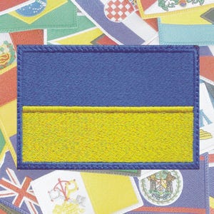 May include: A blue and yellow embroidered patch depicting the flag of Ukraine.