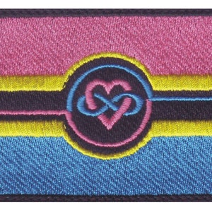 May include: Embroidered patch featuring a pink, yellow, blue, and black pansexual pride flag with a black circle containing an infinity symbol and a heart in the centre.