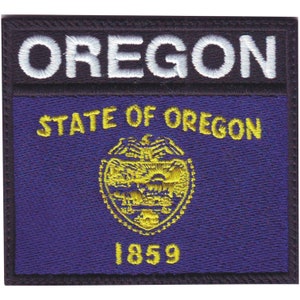 May include: Embroidered patch featuring the state flag of Oregon. The patch is black with a purple background and a yellow seal with the text "State of Oregon" and "1859". The text "Oregon" is white and is located at the top of the patch.