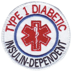 Peut inclure: Écusson rond blanc brodé avec un symbole médical rouge et le texte "TYPE 1 DIABETIQUE INSULINE-DEPENDANT" en noir.