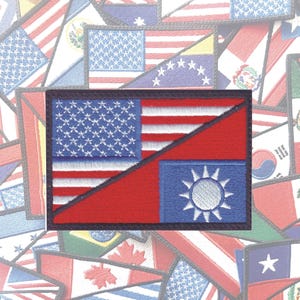 May include: A patch with the American flag and the flag of Taiwan, both sewn together in a diagonal pattern. The American flag is on the left side of the patch and the Taiwanese flag is on the right side. The patch is black and has a white border.
