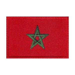 May include: A red embroidered patch with a green five-pointed star in the center. The star has a smaller circle in the center.