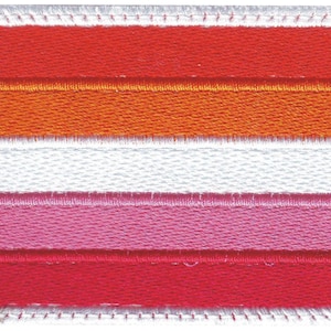 May include: Embroidered patch featuring the lesbian pride flag. The design includes horizontal stripes in shades of red, orange, white, pink, and red, with a white border and a stitched edge.