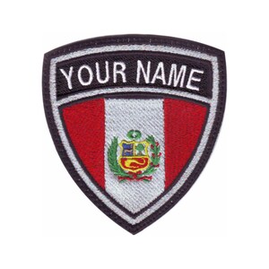 May include: A black and white embroidered patch with a red, white, and red shield with the coat of arms of Peru in the center. The shield is surrounded by a black border with the text "YOUR NAME" in white.