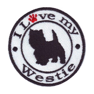 May include: White embroidered patch with a black silhouette of a West Highland White Terrier, a red paw print, and the text "I love my Westie".