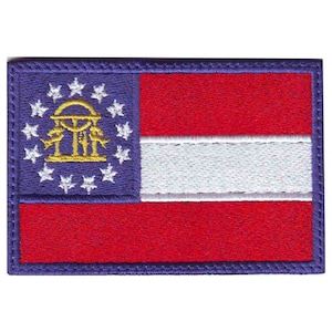 May include: An embroidered patch of the Georgia state flag. The flag is red, white, and blue with a gold dome and stars on a blue background.