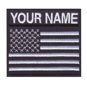 May include: Black and white embroidered American flag patch with the text "YOUR NAME" above the flag.