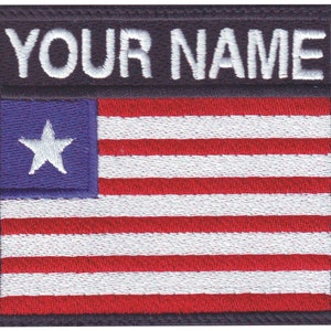 May include: Embroidered patch with a white star on a blue background, followed by red and white stripes, and the text "YOUR NAME" in white on a black background.