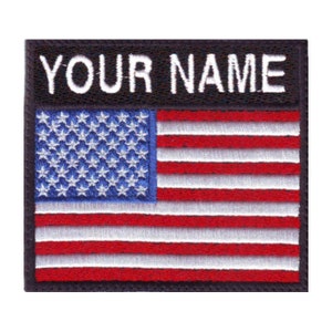May include: A black embroidered patch with the text "YOUR NAME" above an American flag. The flag is red, white, and blue with 13 stripes and 50 stars.