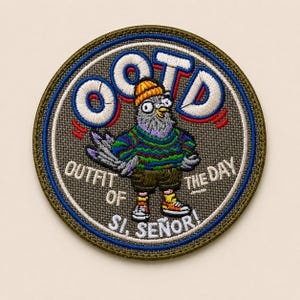 May include: A circular embroidered patch featuring a pigeon wearing an orange beanie, a green and blue patterned sweater, and brown shorts. The text OOTD, OUTFIT OF THE DAY, and SI, SEÑOR! is stitched in white and blue around the central pigeon figure.