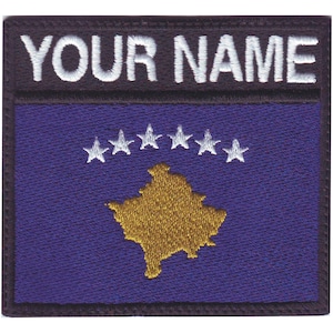 May include: Embroidered patch featuring the flag of Kosovo. The flag is a dark blue field with a gold outline of the country's shape in the center. Six white five-pointed stars are arranged in a semi-circle above the outline. The patch has a black border and the text "YOUR NAME" in white lettering at the top.
