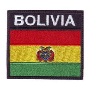 May include: An embroidered patch with the Bolivian flag. The flag is red, yellow, and green with the Bolivian coat of arms in the center. The patch has a black border and the word "BOLIVIA" in white letters at the top.