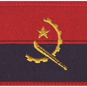 May include: Embroidered patch featuring the flag of Angola. The rectangular patch has a red top, a black bottom, and a central emblem in yellow. The emblem includes a star, a gear, and a machete.