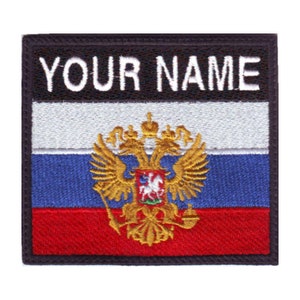 May include: Embroidered patch featuring the text "YOUR NAME" above a horizontal tricolour design of white, blue, and red. A gold double-headed eagle emblem is centered on the blue and red stripes.