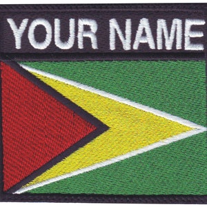 May include: Embroidered patch with the flag of Guyana. The flag is green with a yellow arrow pointing to the right, with a red triangle at the bottom left corner. The text "YOUR NAME" is above the flag.