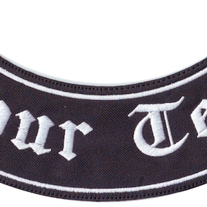 May include: Black and white embroidered patch with the text "Your Text" in a gothic font.
