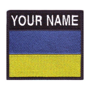 May include: A black and yellow embroidered patch with the text "YOUR NAME" at the top and the Ukrainian flag colors below.