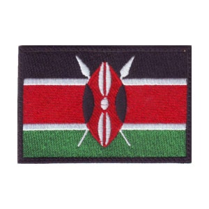 May include: Embroidered patch of the Kenyan flag. The flag is black, red, white, and green with a shield and two spears in the center.