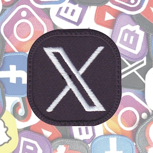 May include: A dark purple embroidered patch with a white "X" in the center. The patch is surrounded by other colorful patches.