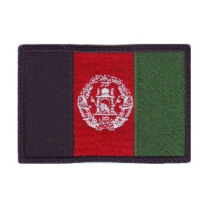 May include: An embroidered patch of the Afghan flag. The flag is red with a green vertical stripe on the right side and a black vertical stripe on the left side. The center of the flag features a white emblem with a mosque and a minaret.