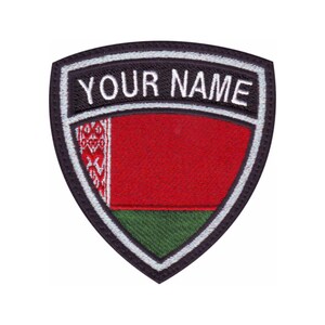May include: A shield-shaped patch with the text "YOUR NAME" at the top. The patch features the flag of Belarus, with a red and green design and a white and red patterned stripe on the left side. The patch is bordered in black and white.