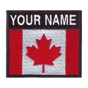 May include: A black and white embroidered patch with the Canadian flag and the text "YOUR NAME" above it.