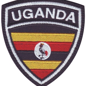 May include: Embroidered patch with the word "UGANDA" in white lettering on a black background. The patch features the Ugandan flag with yellow, red, and black stripes and a white circle with a black crested crane in the center.