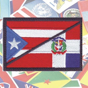 May include: Embroidered patch featuring the flags of Puerto Rico and the Dominican Republic. The flags are split diagonally, with the Puerto Rican flag on the left and the Dominican Republic flag on the right. The patch is surrounded by a black border.