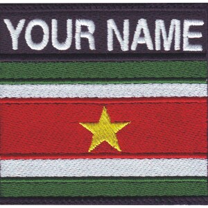 May include: Embroidered patch with the flag of Suriname. The flag is green, white, red, and green with a yellow star in the center. The text "YOUR NAME" is above the flag.