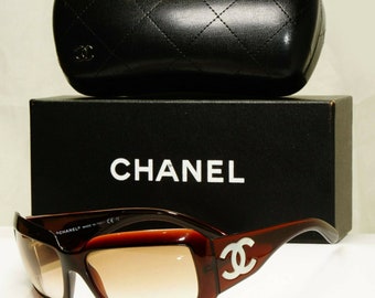 Vintage CHANEL brown frame sunglasses with large CC charms at