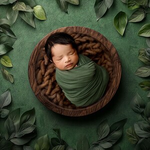 May include: A newborn baby sleeping peacefully in a wooden bowl lined with brown yarn. The bowl is surrounded by green leaves.