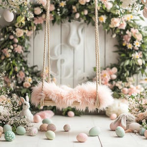 May include: A whimsical Easter-themed scene featuring a small swing with a fluffy pink seat suspended by rope. The background includes a floral wreath and scattered pastel-colored Easter eggs. Decorative bunnies and flowers complete the spring setting.