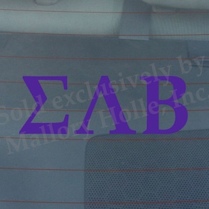 May include: Purple vinyl decal with the Greek letters "ΣΑΒ" on a blue background. The decal is for a car window and has the text "Sold exclusively by Mallory Holle, Inc." on it.