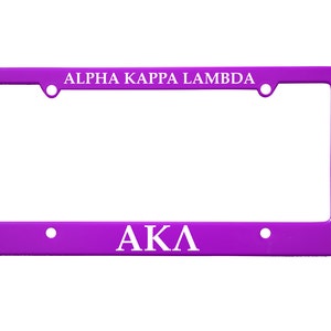 May include: Purple plastic license plate frame with white text that reads "ALPHA KAPPA LAMBDA" at the top and "AKA" at the bottom.