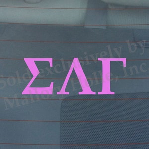 May include: Pink vinyl decal with the Greek letters Sigma Lambda Gamma.