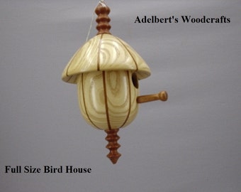 This beautiful lathe turned segmented bird house is made of Mahogany & Ash.It's 10 1/2" tall x 6" in dia.