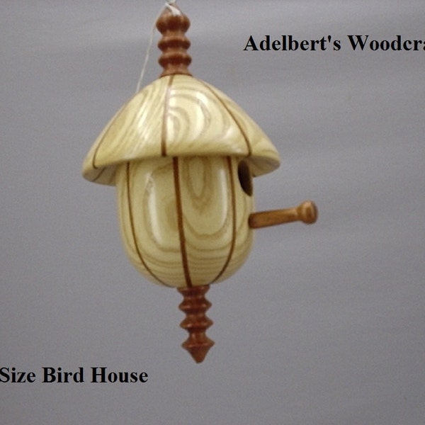 This beautiful lathe turned segmented bird house is made of Mahogany & Ash.It's 10 1/2" tall x 6" in dia.