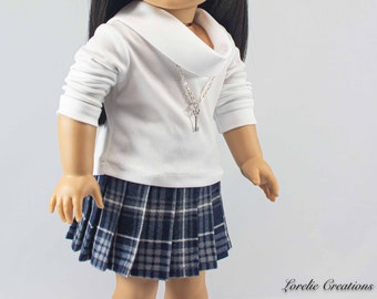 May include: A white long-sleeved shirt with a cowl neck and a silver key necklace. The shirt is paired with a blue and white plaid pleated skirt.