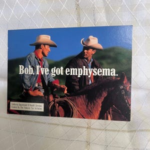 May include: An advertisement featuring two cowboys in hats, one on horseback. The text reads, "Bob, I've got emphysema." The ad is from the California Department of Health Services, funded by the Tobacco Tax Initiative. The background shows a blue sky and green hills.